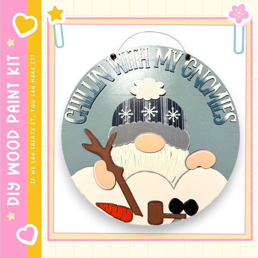 A wooden sign featuring a gnome holding a carrot and a snowman, with the text "Chilling with my gnomes" written on it.