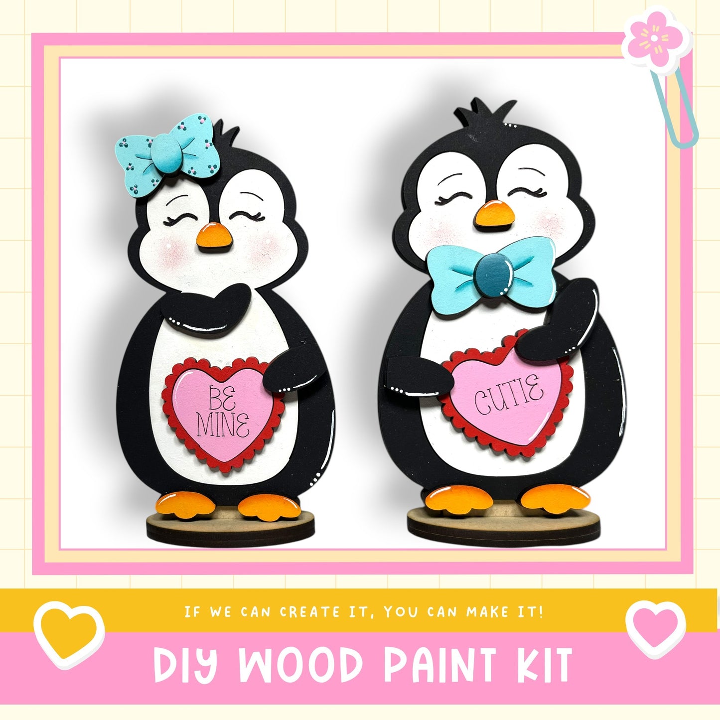 two wooden penguin figurines, each holding a heart-shaped sign with a Valentine's Day message. The penguins are wearing bows and appear to be made of wood. The image also includes text that says "DIY WOOD PAINT KIT" and "IF WE CAN CREATE IT, YOU CAN MAKE IT!"