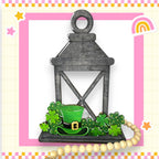 a st patrick's day card with a green lantern and shamrocks