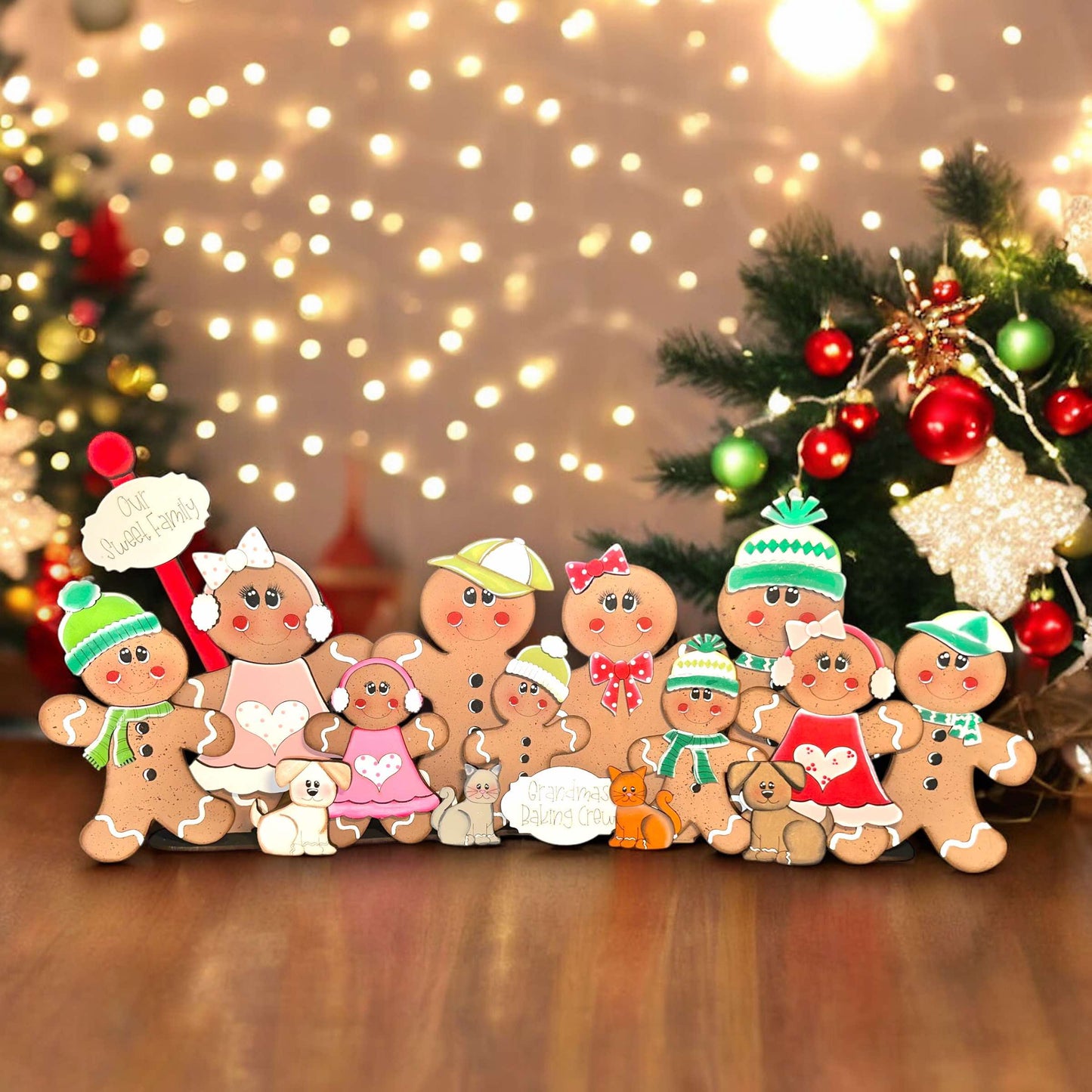 a group of gingerbread men standing next to a christmas tree