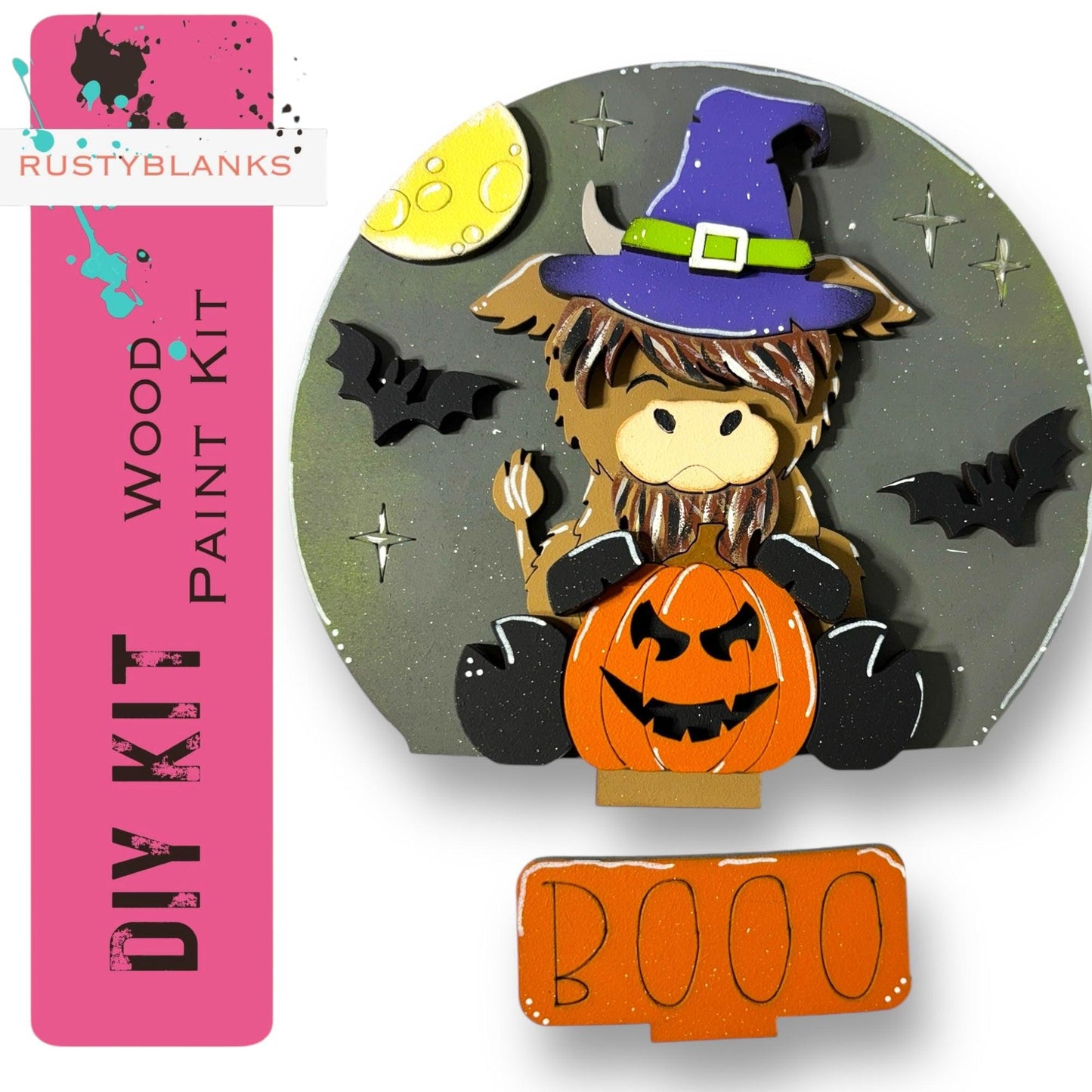 a paper cut out of a witch sitting on a pumpkin