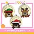 three wooden ornaments with bear faces, each wearing a different holiday-themed hat. The text on the ornaments reads "BEAR HUGS & HOLIDAY CHEER".