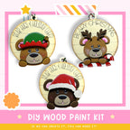 three wooden ornaments with bear faces, each wearing a different holiday-themed hat. The text on the ornaments reads "BEAR HUGS & HOLIDAY CHEER".
