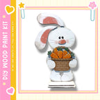 A wooden toy rabbit holding a basket of carrots.