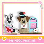 two wooden toy dogs, one holding a heart-shaped object and the other holding a letter, standing next to a mailbox labeled "LOVE LETTERS".