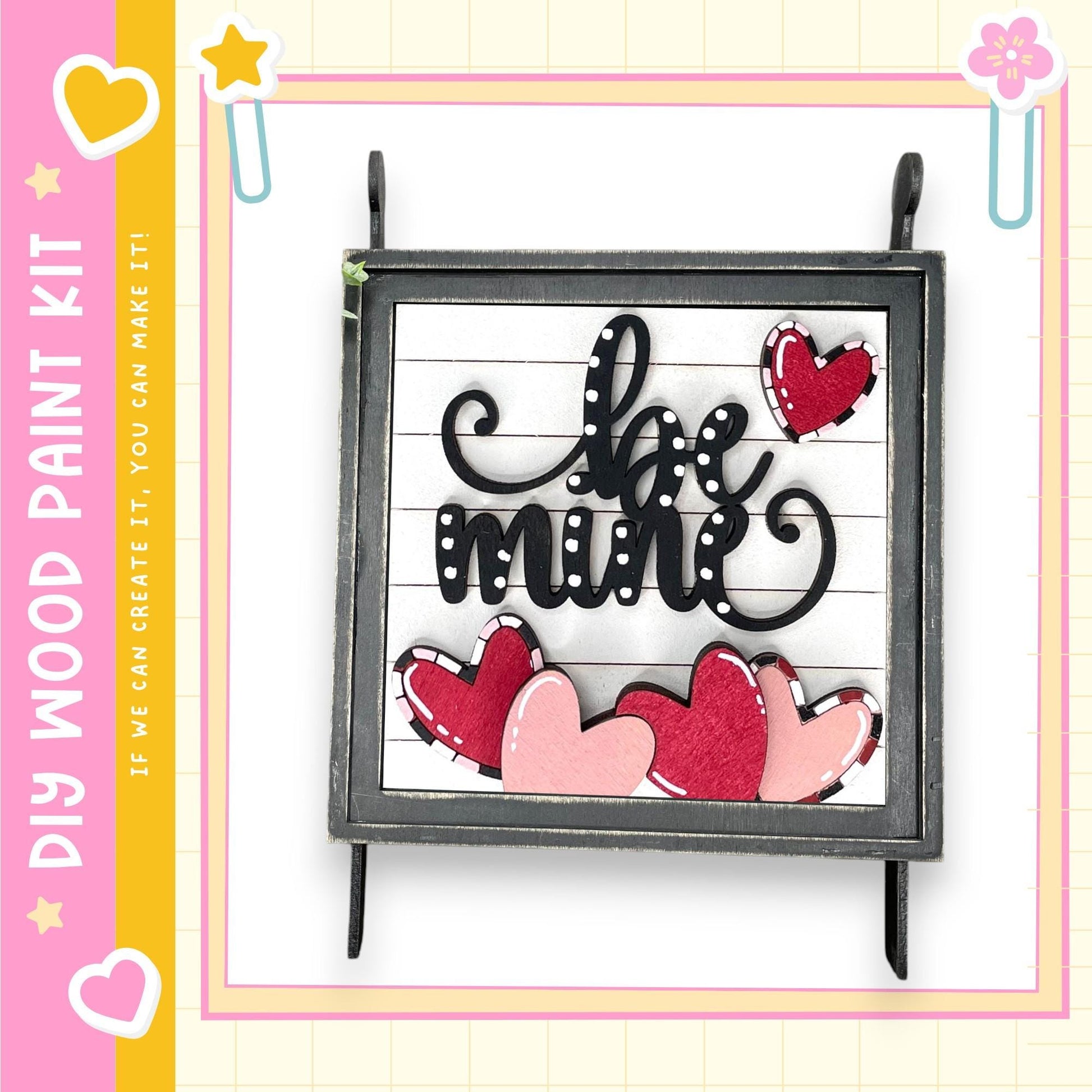 a wooden frame with a decorative message and heart-shaped cutouts.