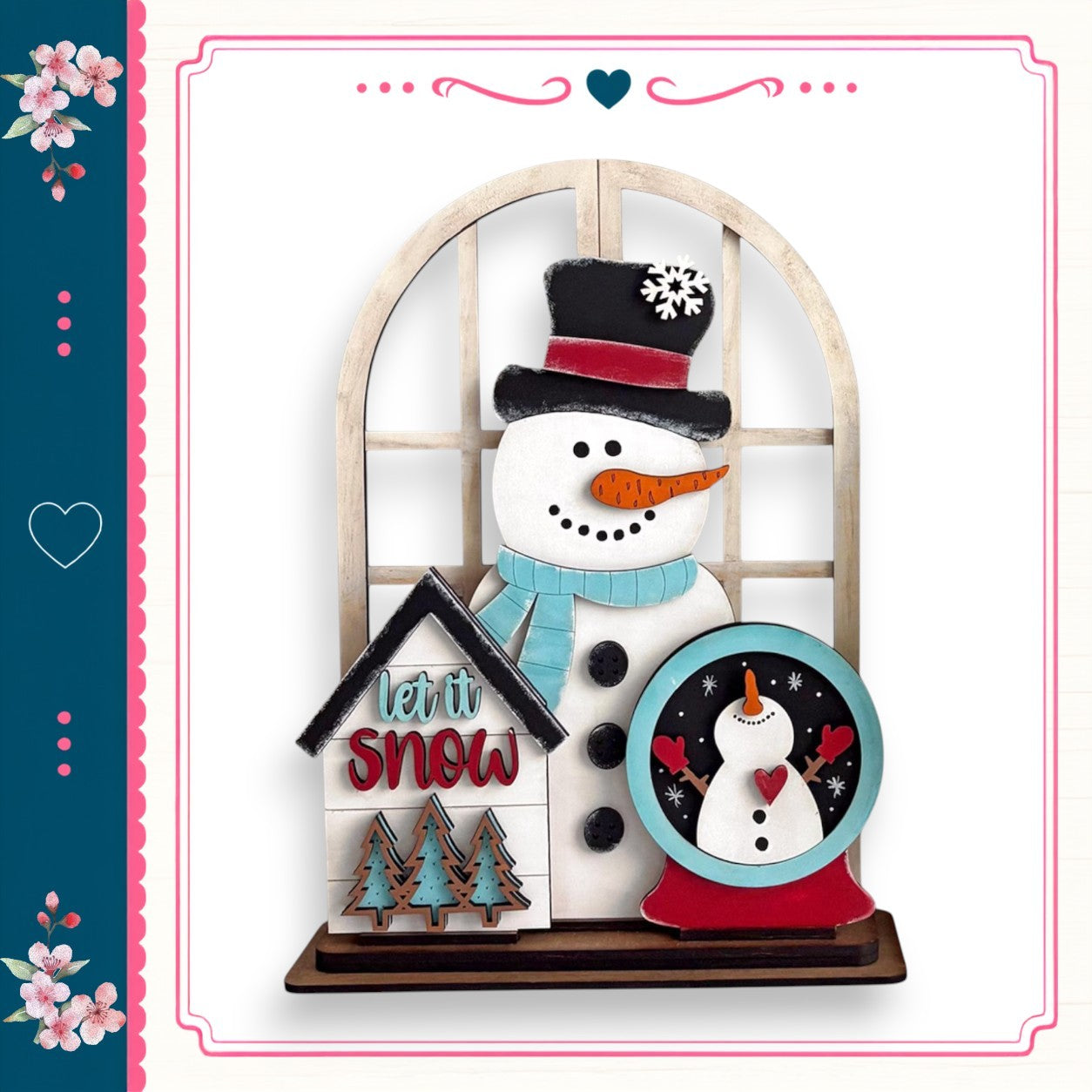 A snowman figure with a clock and a sign that says "let it snow" is displayed in a decorative wooden frame.