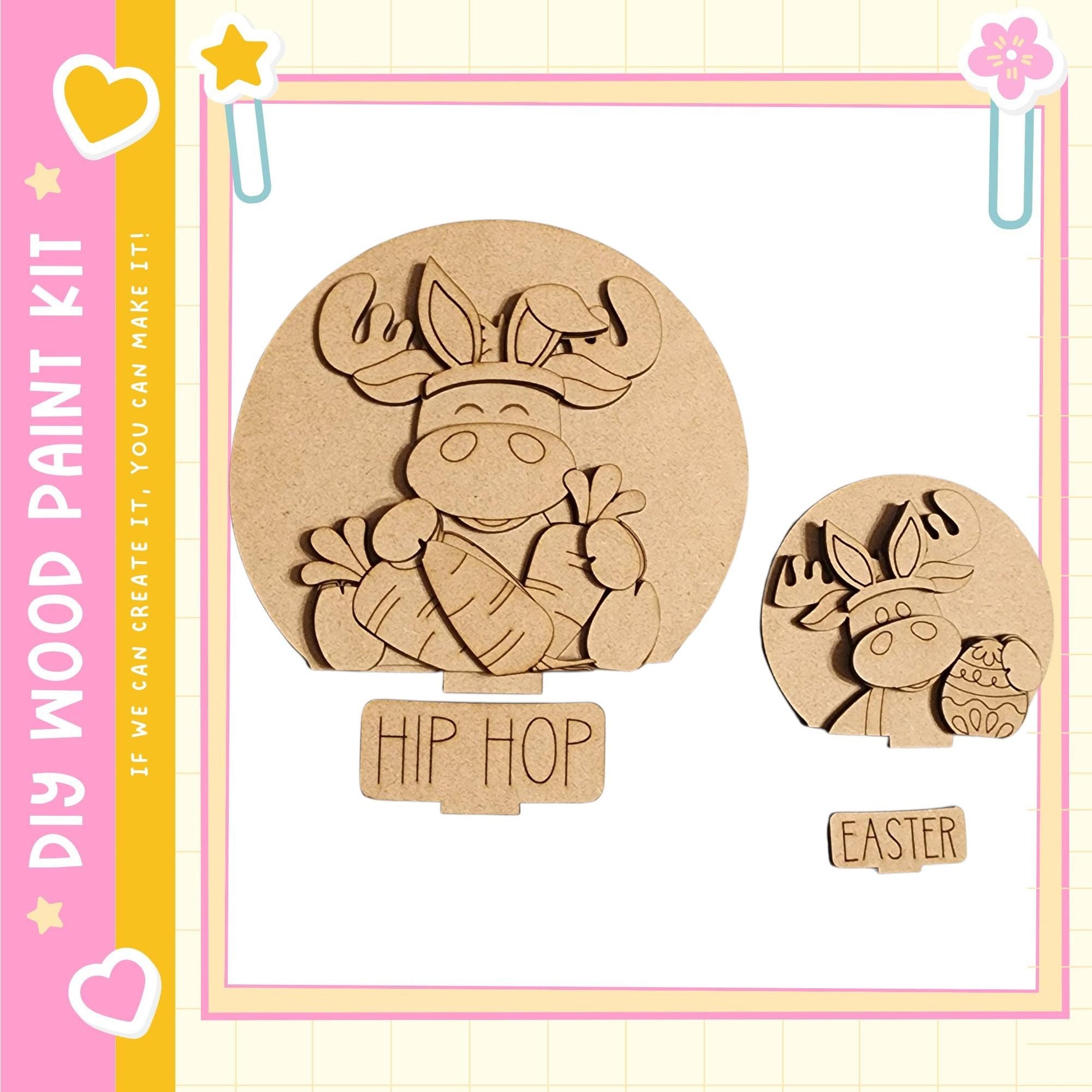 two wooden cutouts of cartoon animals, one larger and one smaller, both with the word "HIP HOP" written on them. The larger cutout is a moose, and the smaller one is a deer. The cutouts are set against a pink and yellow background with decorative elements such as hearts and stars.