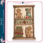 The image is a wooden display with various gingerbread-themed decorations, including gingerbread men, gingerbread cookies, and other festive elements. The display is titled "Sweeten the Season" and includes phrases like "Rolling Out Some Christmas Cheer" and "One Brushstrokes".