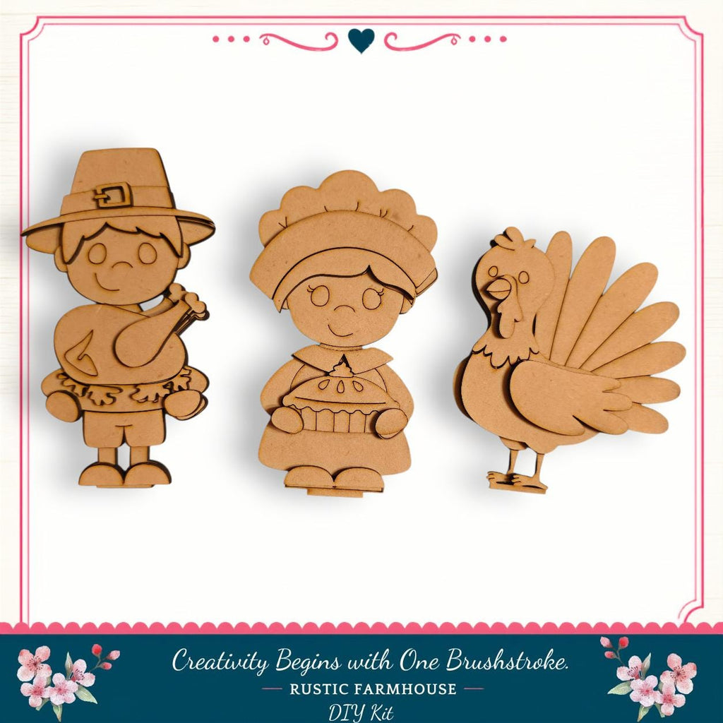 three wooden cutouts of a boy, a girl, and a turkey, arranged in a row.