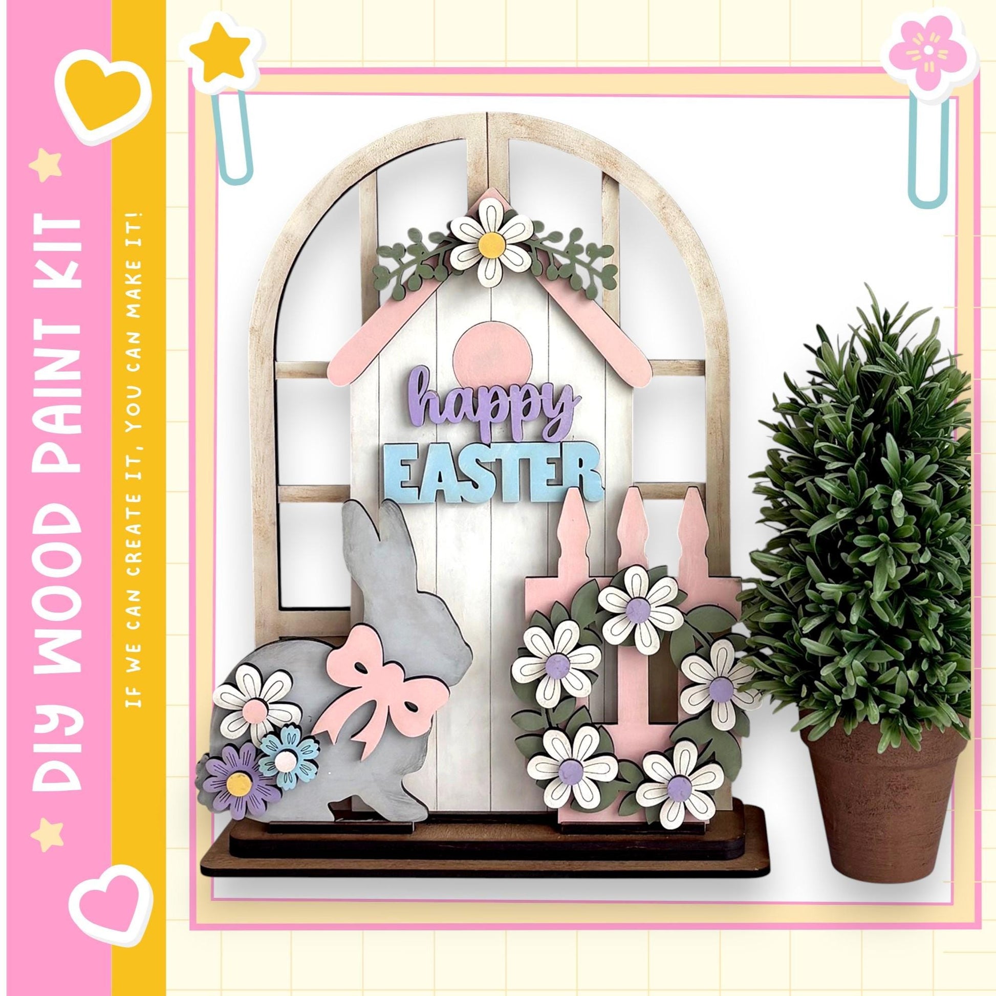 a wooden Easter decoration kit, including a wooden house, a bunny, and a wreath, all decorated with flowers and the word "Easter".