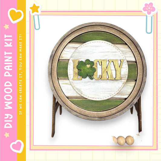 a wooden barrel with the word "Lucky" written on it, surrounded by a decorative border.