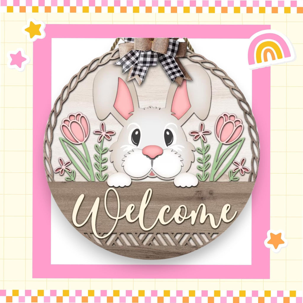 a welcome sign with a bunny in a basket
