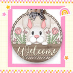 a welcome sign with a bunny in a basket