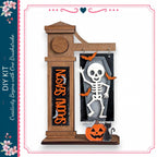 A Halloween-themed DIY kit featuring a skeleton decoration, a carved pumpkin, and a clock.