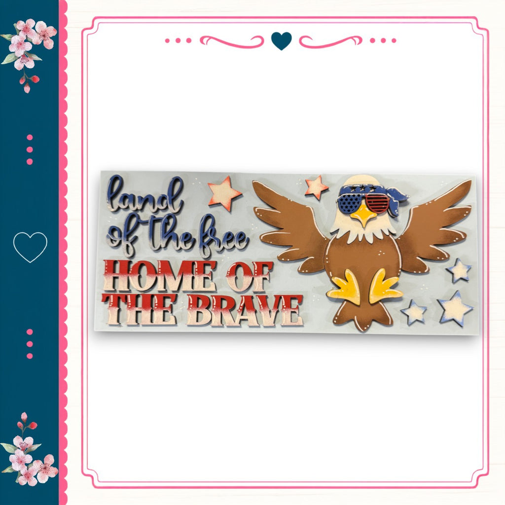 a patriotic design with an eagle wearing sunglasses and surrounded by stars, along with the text "Land of the free Home of the brave".