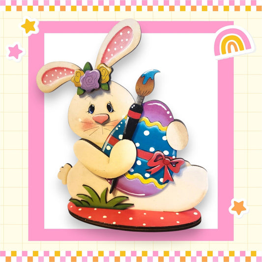 a picture of a bunny holding an easter egg