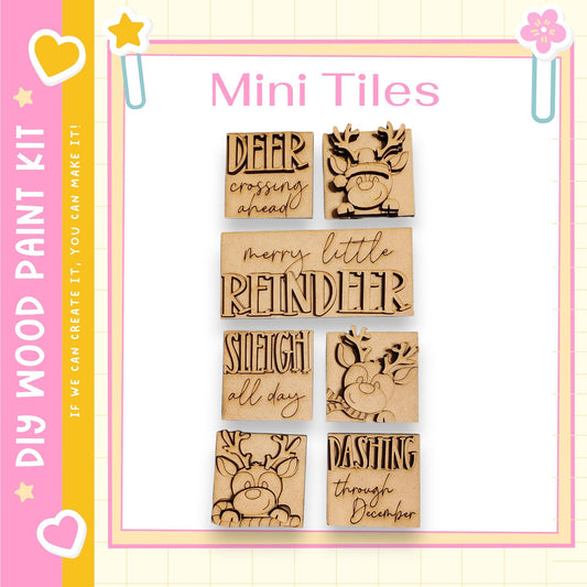 a set of six wooden tiles with various holiday-themed sayings and designs, including "DEAR CROSSING AHEAD", "Merry Little REINDER", "SLIEGHT ALL DAY", "DASHING THROUGH DECEMBER", and "IF WE CAN CREATE IT, WE CAN MAKE IT".