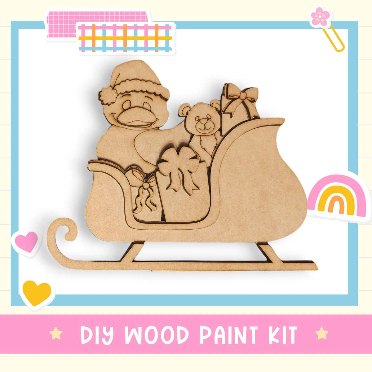 The image is a DIY wood paint kit featuring a wooden Santa Claus figure sitting on a sled, holding presents and a teddy bear.