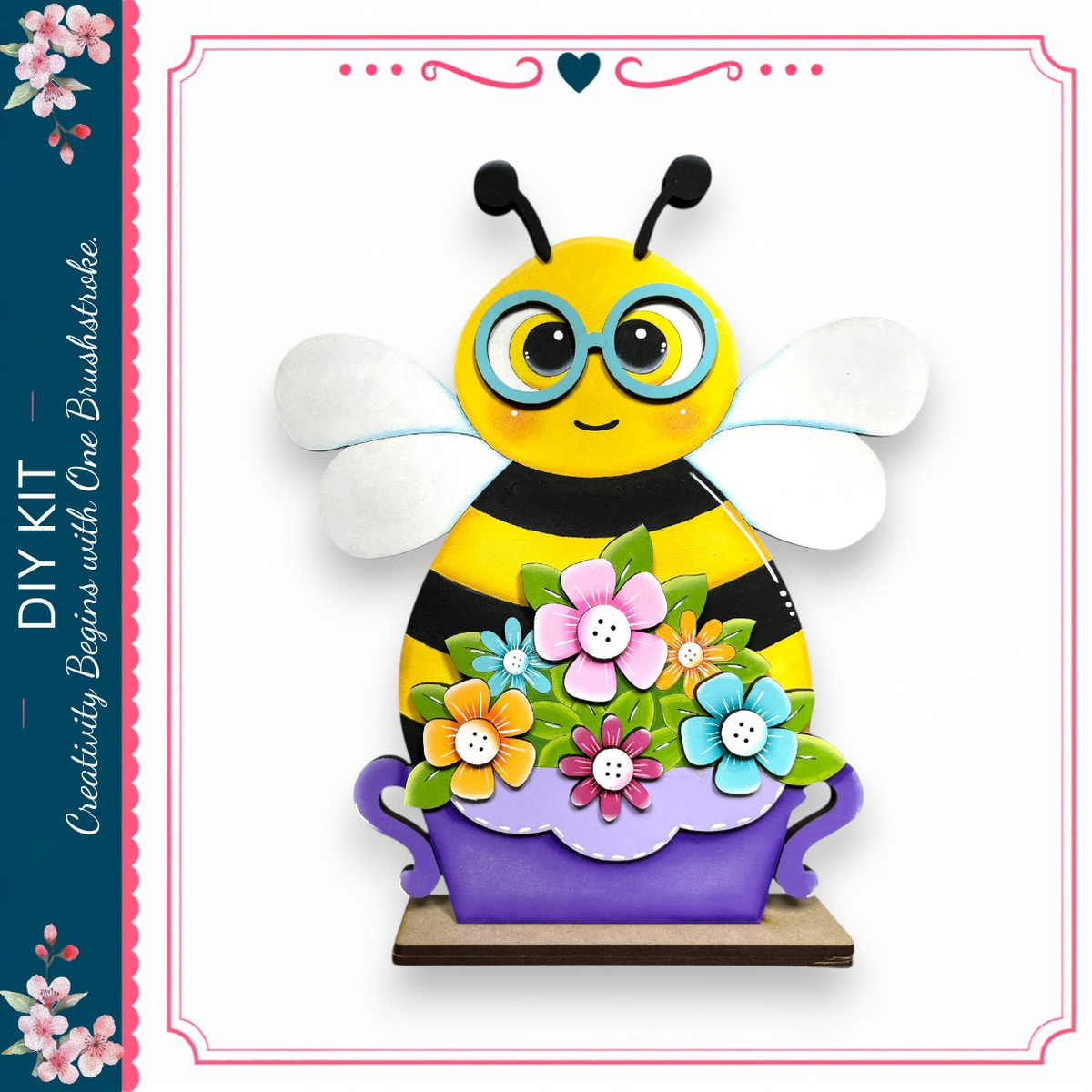 A colorful, hand-painted bee figurine with a floral design on its body and wings, sitting in a purple vase.