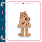 A wooden figure of a girl holding a lollipop and wearing glasses is depicted in the image.