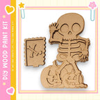 a skeleton figure holding a pumpkin, which appears to be part of a Halloween-themed kit.