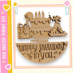 A wooden birthday cake with candles and decorations, along with the text "Happy Birthday to you" carved into it.
