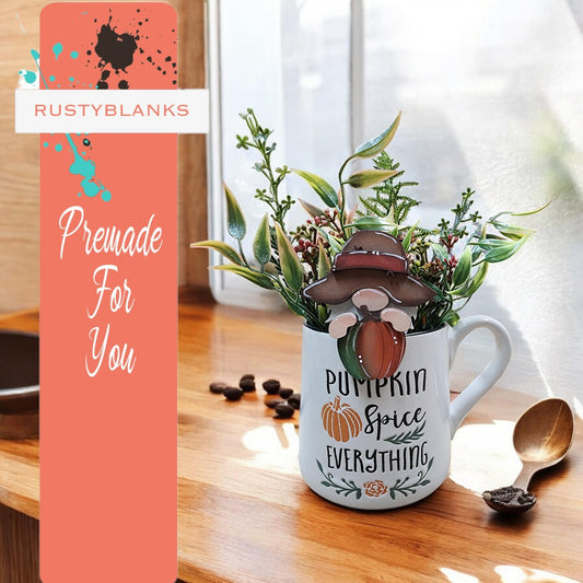 a coffee mug with a plant inside of it