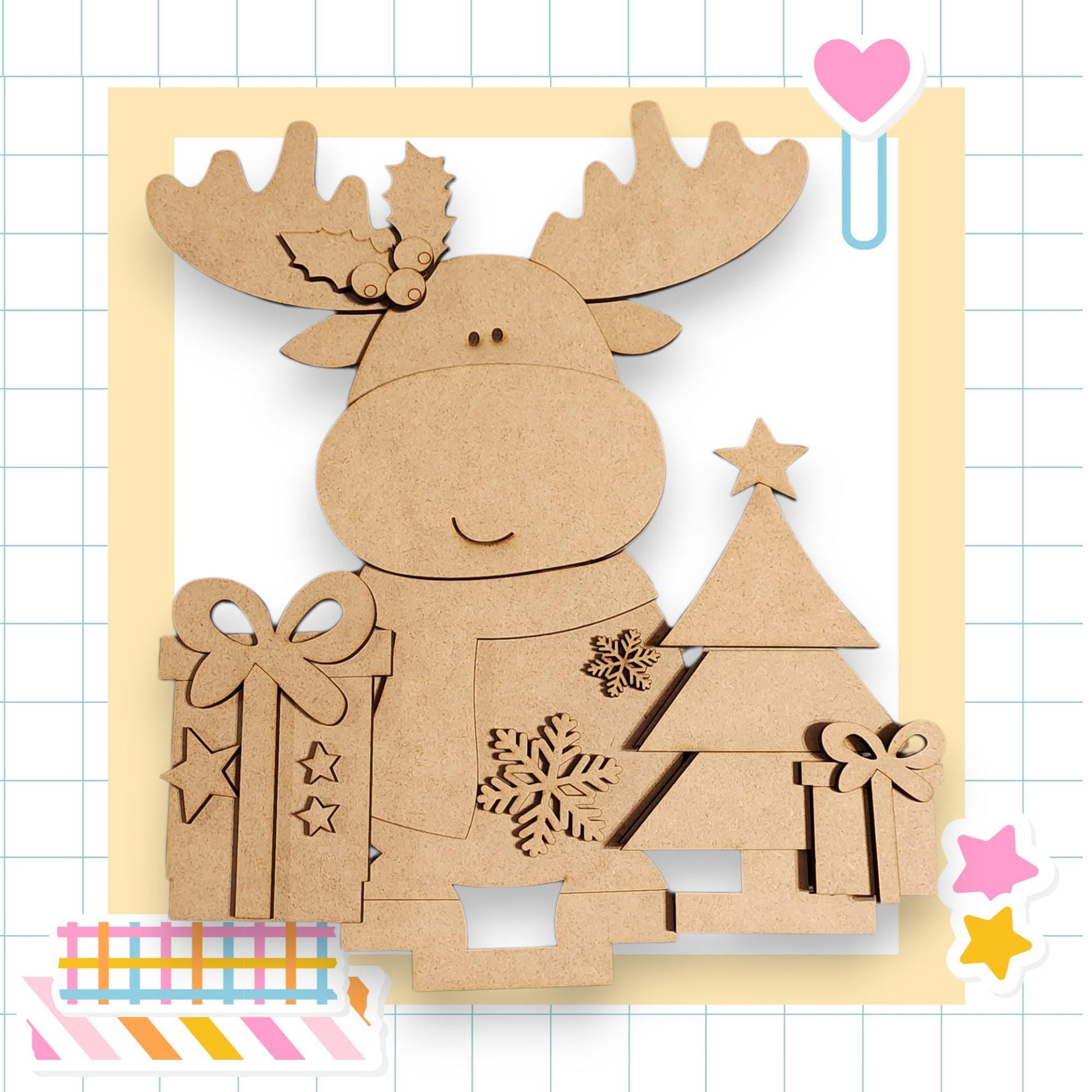 A cardboard cutout of a smiling moose holding a gift box and a Christmas tree, set against a grid background with a heart and stars.