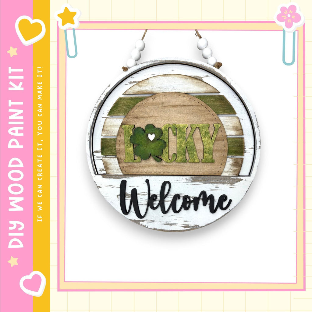 A circular sign with the word "Lucky" and the word "Welcome" written on it, hanging on a wall.