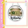 A circular sign with the word "Lucky" and the word "Welcome" written on it, hanging on a wall.