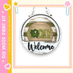 A circular sign with the word "Lucky" and the word "Welcome" written on it, hanging on a wall.