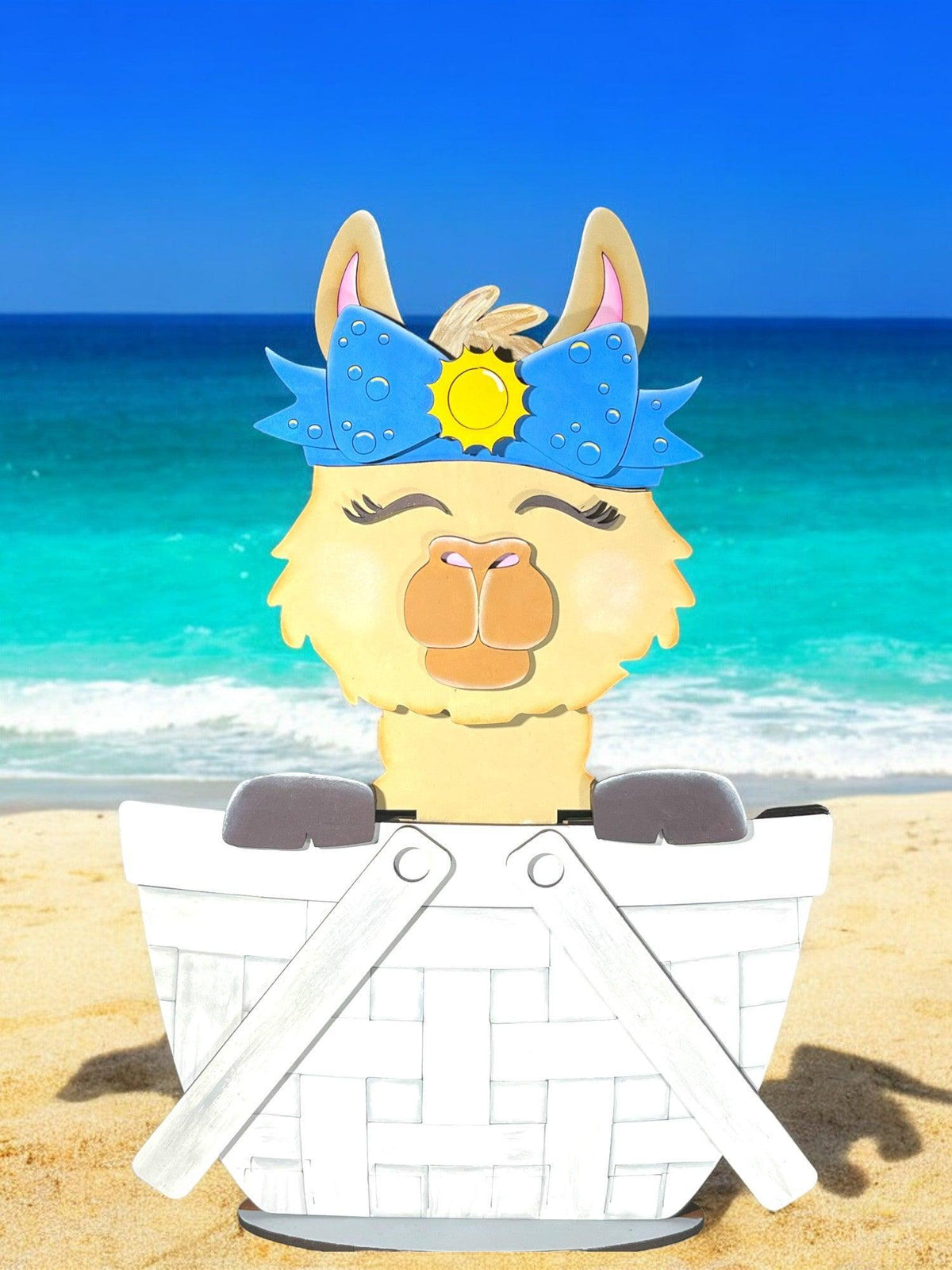 a paper cut out of a llama on a beach