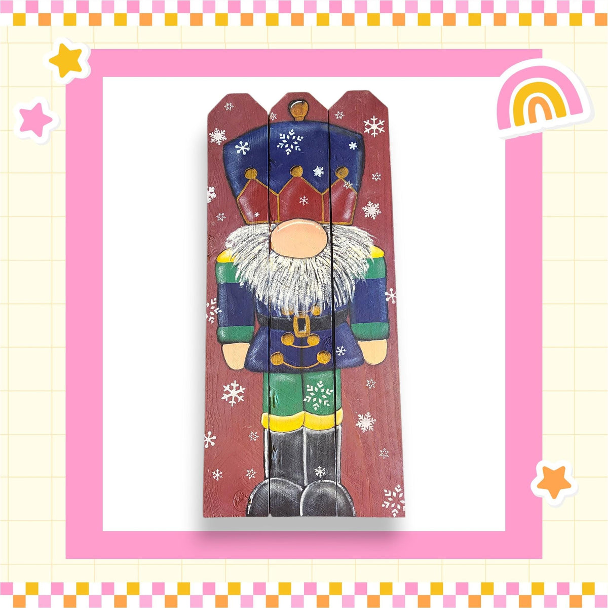 A wooden nutcracker figure with a colorful outfit and a crown, surrounded by snowflakes, is depicted in the image.