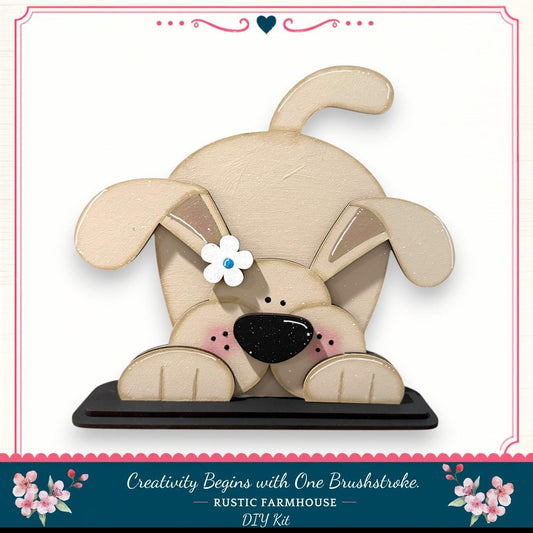 A wooden dog figurine with a flower in its eye, sitting on a black base.