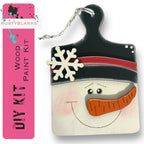 a wooden snowman ornament with a black hat and red nose