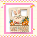 A wooden Easter bunny wearing glasses and holding carrots, with the text "Easter Blessings" written on a wooden plaque.