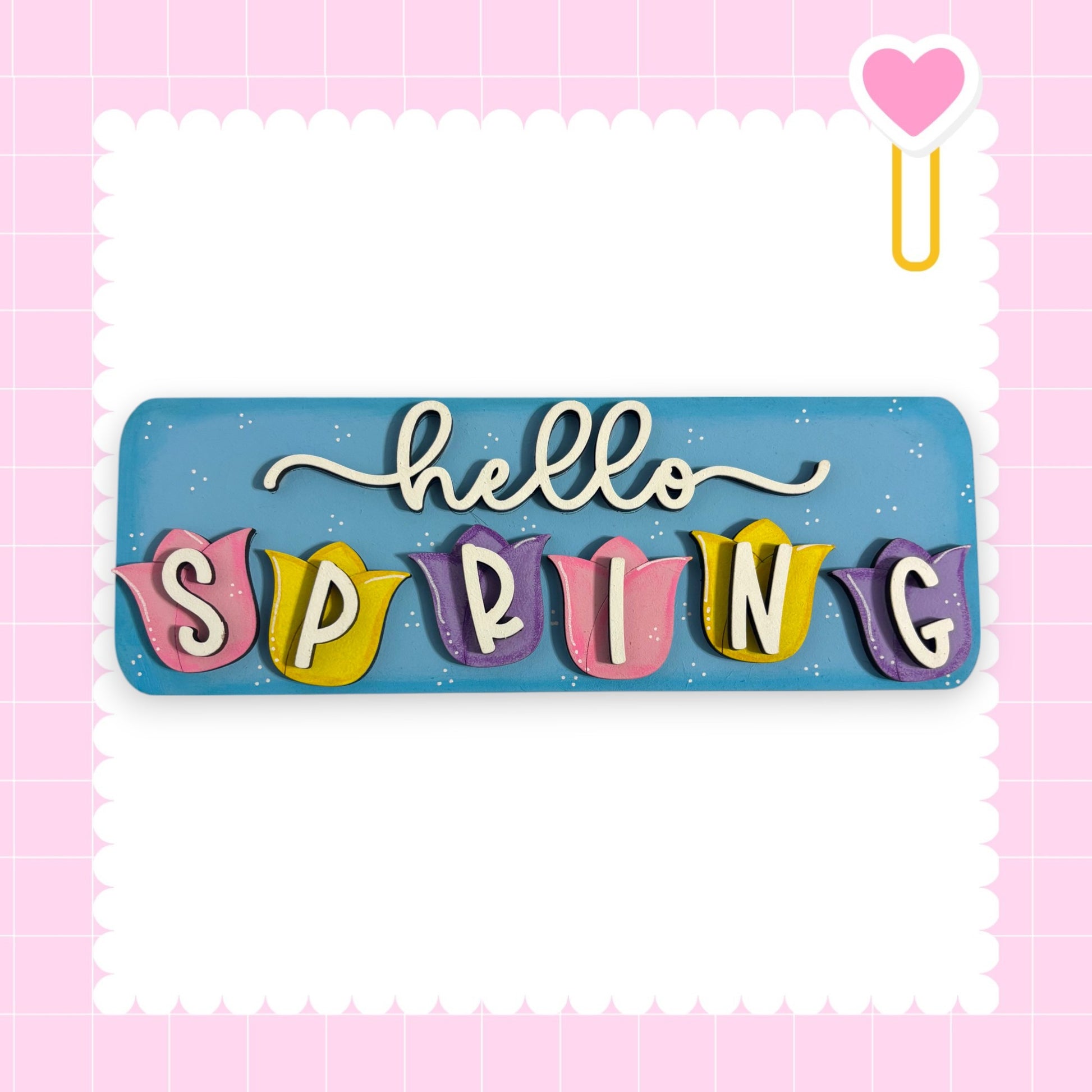 A colorful sign with the word "SPRING" written on it, surrounded by decorative elements such as hearts and flowers.