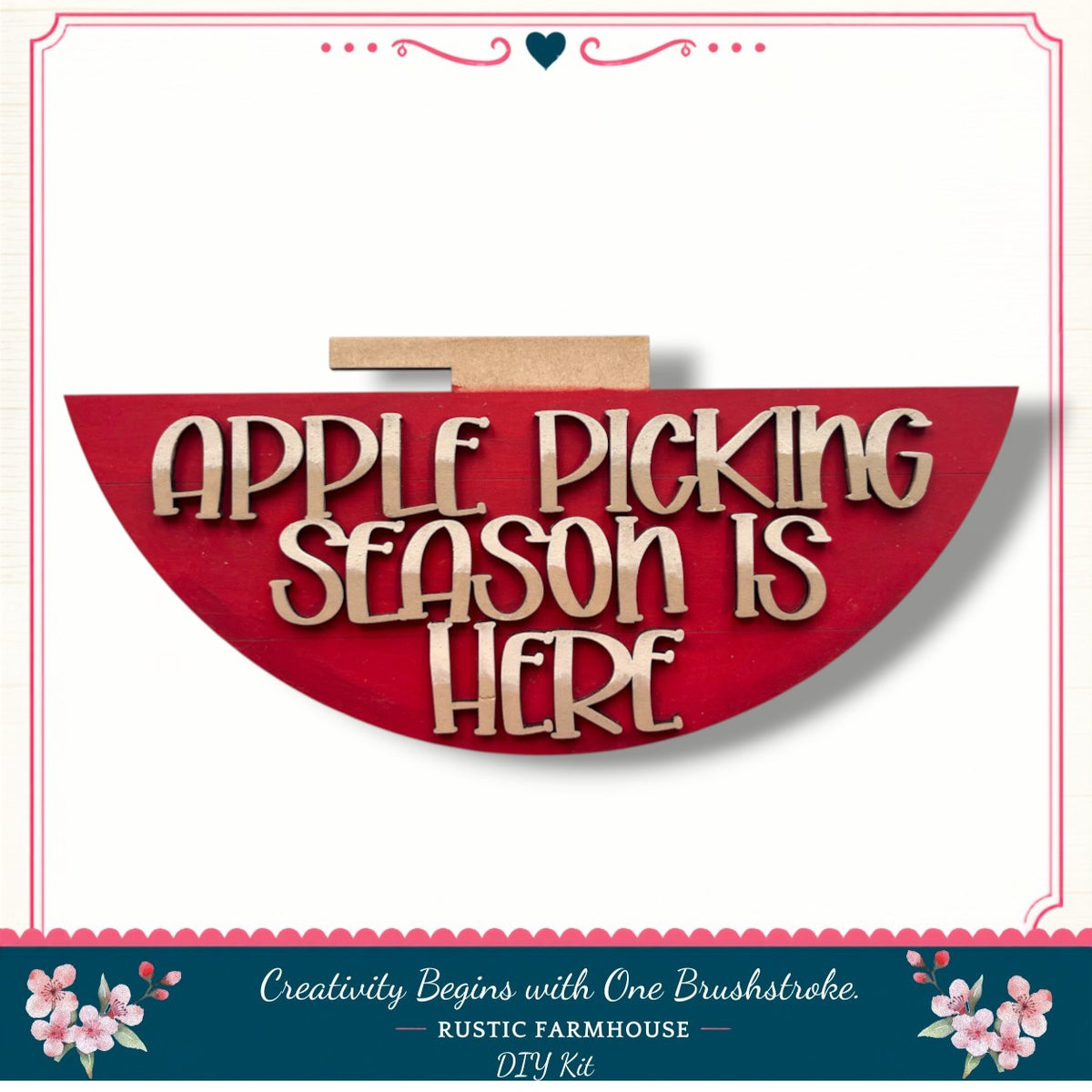 a red sign with the text "Apple Picking Season is Here" in a decorative font, surrounded by a floral border.