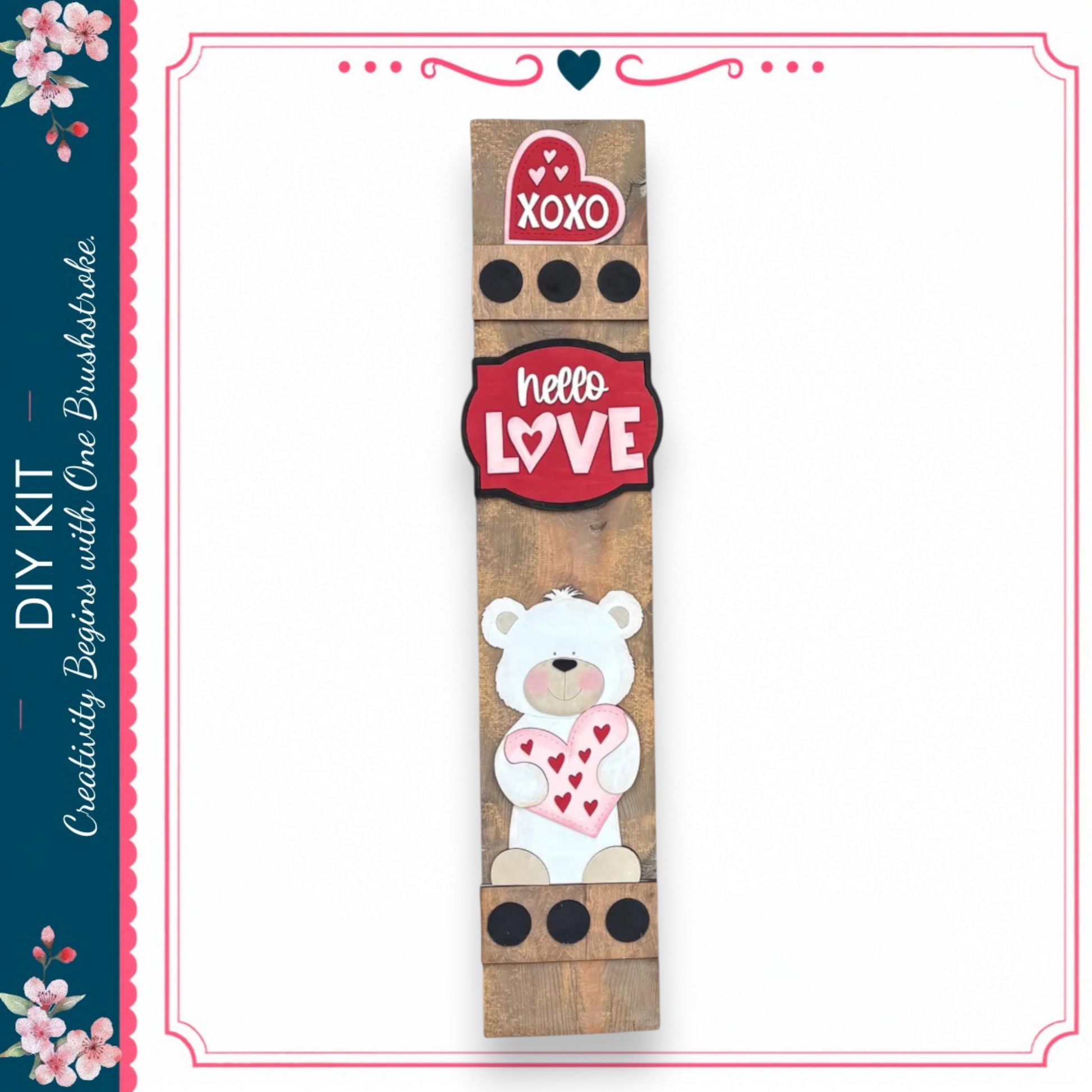 a wooden sign with a teddy bear and hearts, along with the words "XOXO" and "Hello Love" displayed on it.