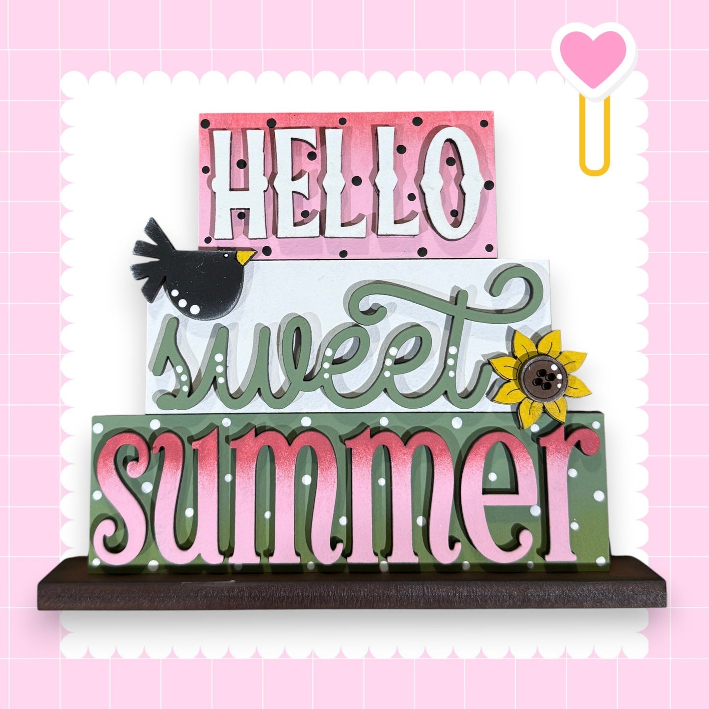 A colorful sign with the text "Hello sweet summer" in a playful, decorative font.