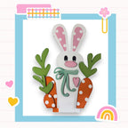 a paper cut of a bunny holding carrots