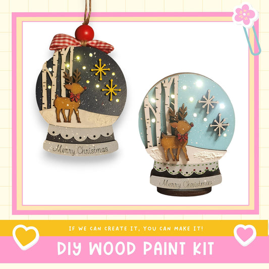 two Christmas ornaments, each with a unique design and a red bow. The ornaments are displayed against a white background, and there is text at the bottom of the image that reads "DIY WOOD PAINT KIT" and "IF WE CAN CREATE IT, YOU CAN MAKE IT!"