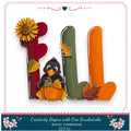 A colorful and whimsical DIY kit featuring a bird, a pumpkin, and autumn leaves, all arranged to spell out the word "FALL".