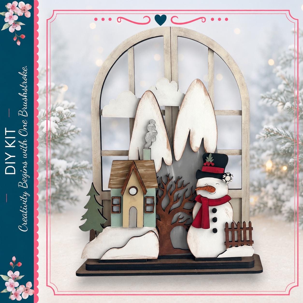 A wooden snowman stands in front of a window, with a small house and tree visible through the window. The scene is set against a snowy landscape with trees and a clear sky.