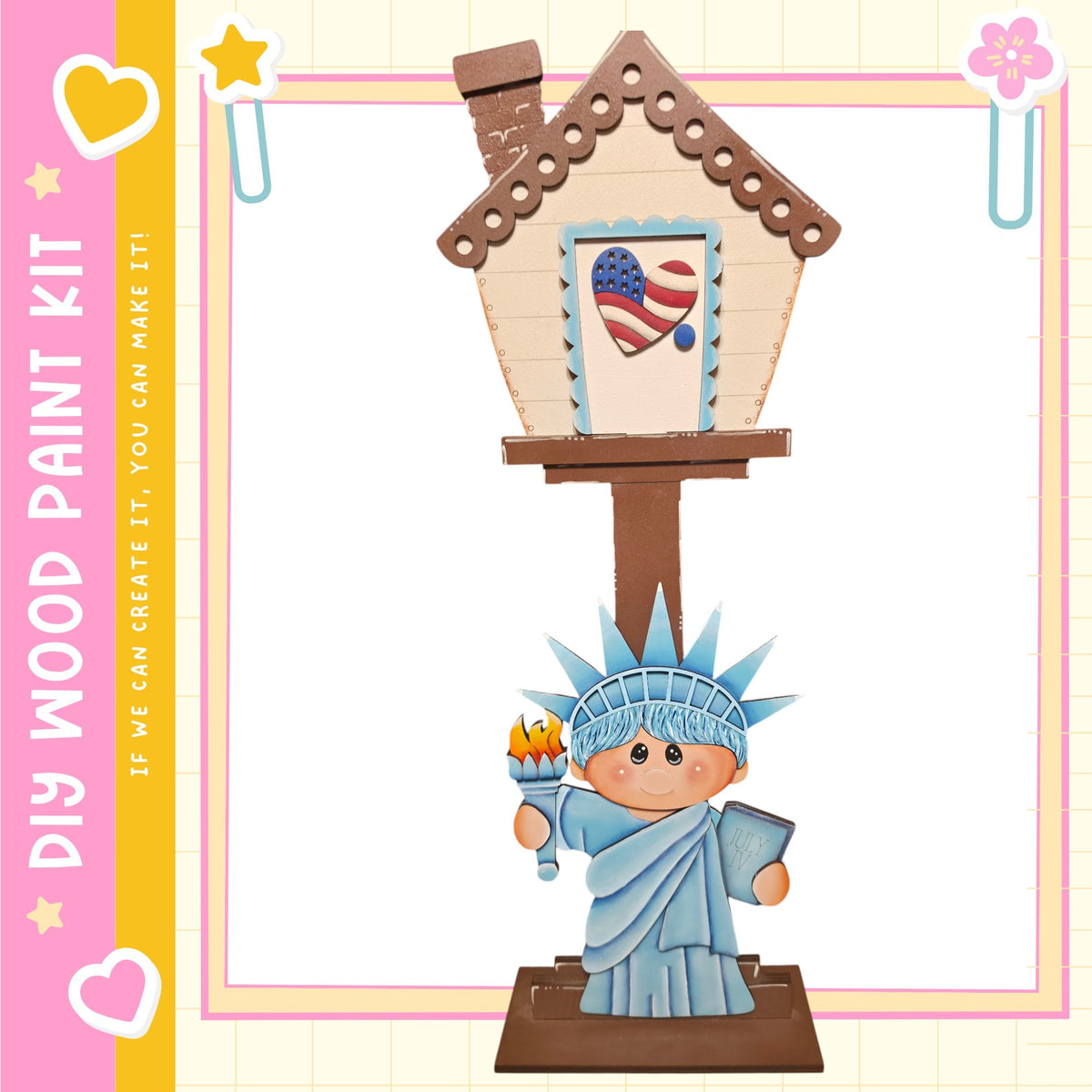A wooden house with a painted American flag on the front, featuring a small statue of the Statue of Liberty.