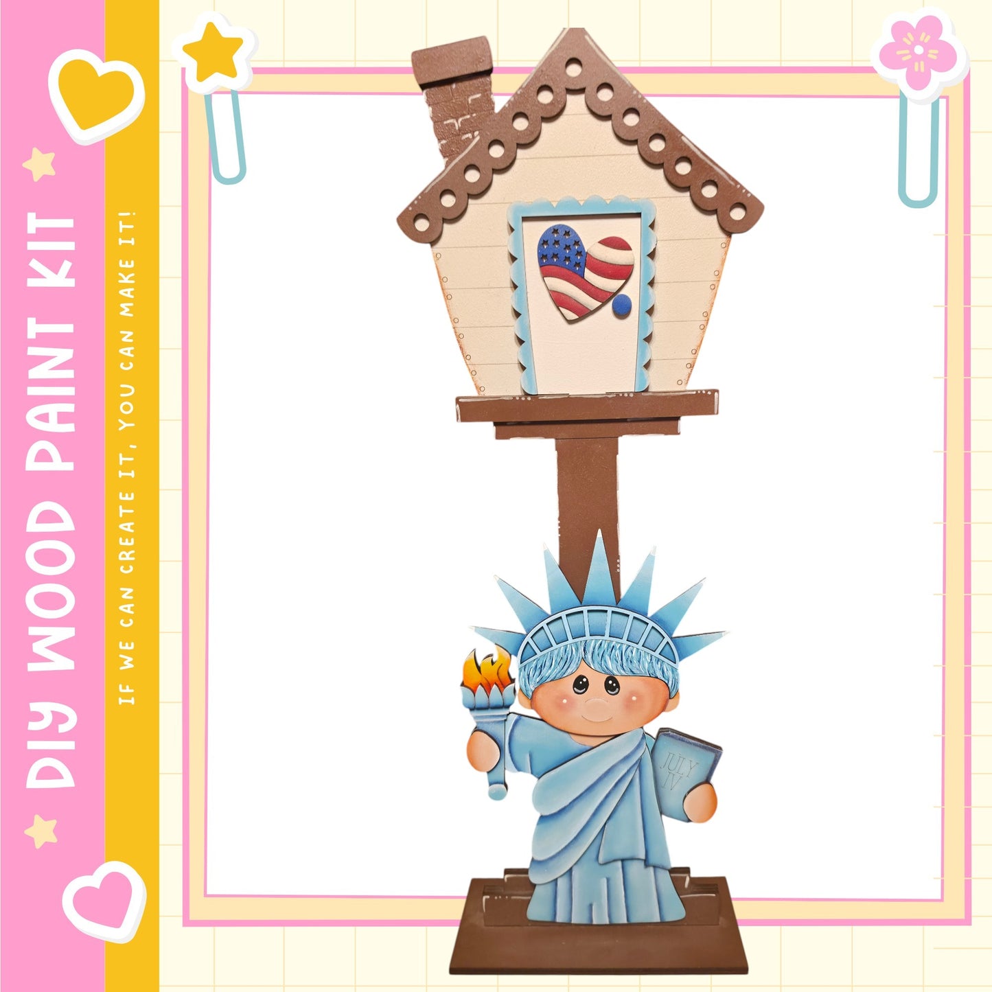 A wooden house with a painted American flag on the front, featuring a small statue of the Statue of Liberty.