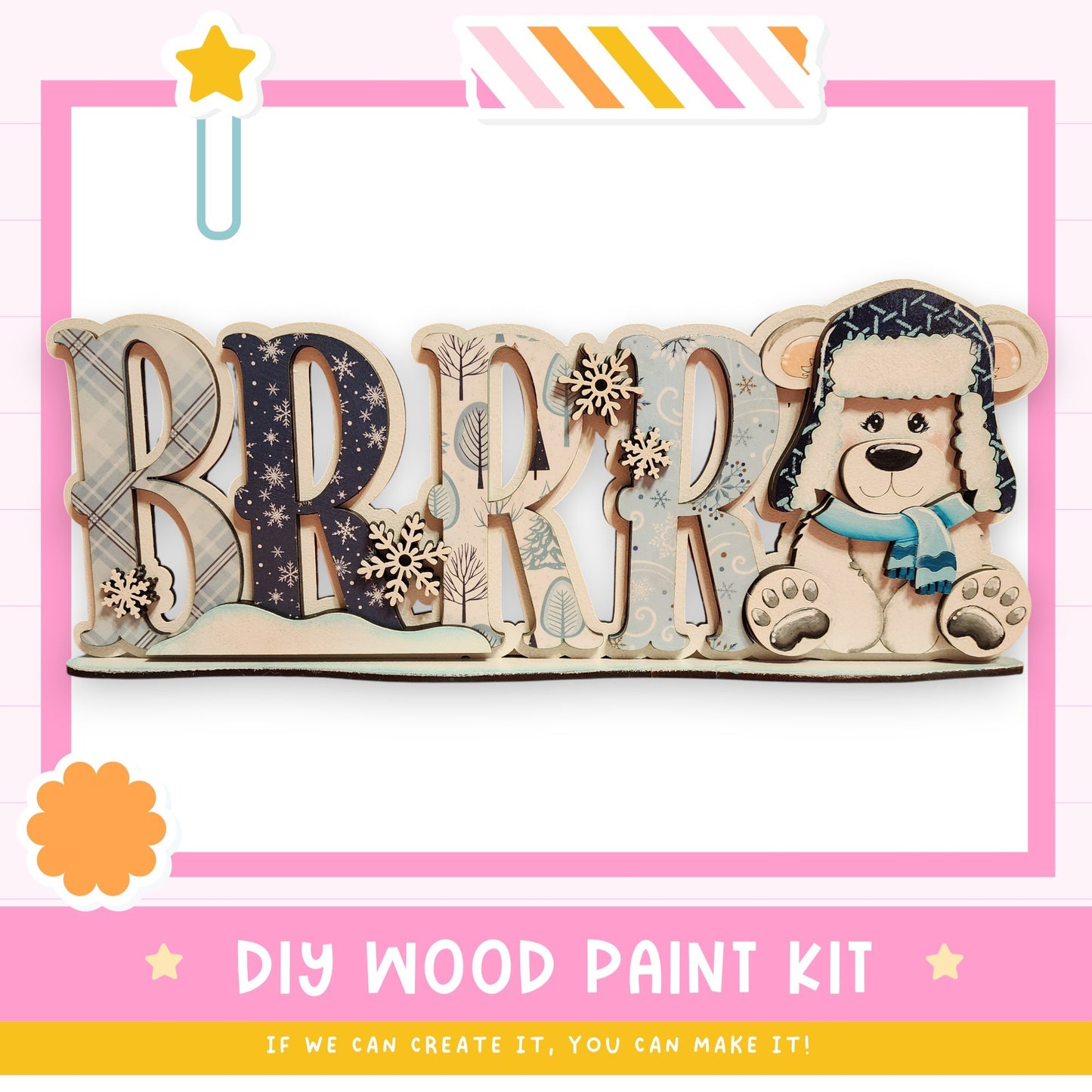 The image is a DIY wood paint kit featuring a wooden sign with the word "BRRRR" and a teddy bear wearing a blue scarf.