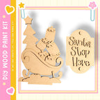 a DIY paint kit for creating a Christmas tree and a Santa Claus sign, along with a pink and yellow border.