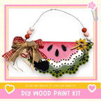 The image is a DIY wood paint kit advertisement, featuring a colorful wooden fruit basket with a bow and beads, along with the text "If we can create it, you can make it!"